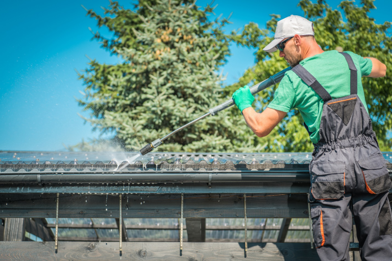 Man washing gutter system